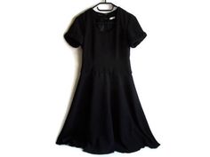 This is a beautiful vintage black dress. Very classic and flattering. This dress will serve you for years as it is so classic and timeless. Great for evening events. It has a modest round neck and short sleevs. Has a zip down the back as well as 2 hooks. There are two small loop holes for a belt, but if you wish you can easily remove them.The fabric drapes beautifully and the skirt gives a very feminine look.Size: womens S (please check measurements below)Measurements of the dress lying flat:len Classic Black A-line Vintage Dress, Vintage Black A-line Mini Dress, Formal Fitted Vintage Dress, Black Knee-length Vintage Dress For Evening, Black Knee-length Vintage Evening Dress, Black Vintage Midi Dress For Evening, Chic Black Vintage Dress For Evening, Classic Vintage Dress With Short Sleeves For Evening, Classic Vintage Evening Dress With Short Sleeves