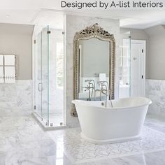 a white bath tub sitting in a bathroom next to a walk in shower and a large mirror