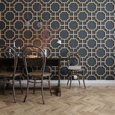 an elegant dining room with black and gold wallpaper, two chairs and a table