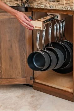 there are pictures of kitchen cabinets with pots and pans hanging from the racks in them