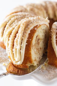 a close up of a cake on a plate with a spoon