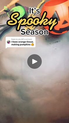 an orange and black pumpkin sitting on top of a cloud filled sky with the words it's spooky season