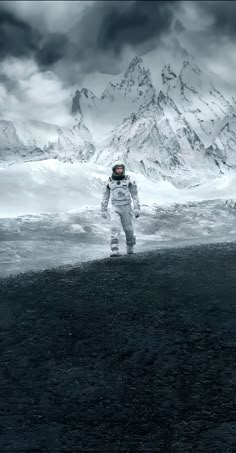 an astronaut standing in the middle of a field with mountains in the backgroud