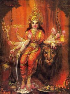 the hindu goddess sitting on top of a lion