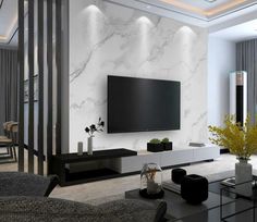 a modern living room with white marble walls and black furniture in front of a flat screen tv