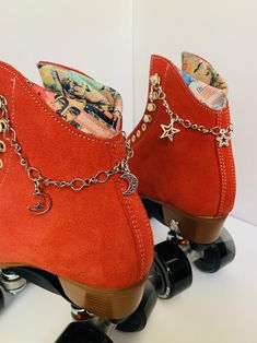 a pair of red roller skates with chains on them