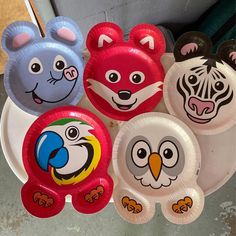 several paper plates with animal faces on them