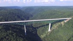 an aerial view of a bridge in the mountains