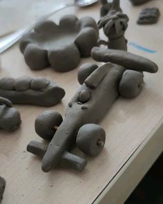 clay sculptures are sitting on a table next to scissors and other crafting supplies,