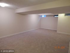 an empty living room with carpeted floors and no furniture in the house or apartment