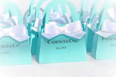 small blue bags with white bows on them are sitting side by side in front of each other