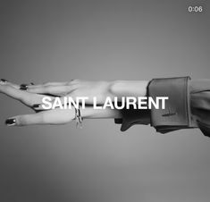 a woman's arm with the words saint laurent in white on top of it