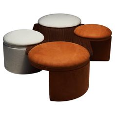 four different colored stools sitting next to each other