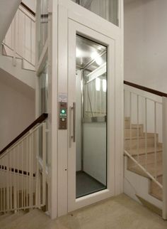 an open door leading to the second floor in a building with stairs and railings