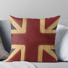 a red and yellow union jack pillow on a couch