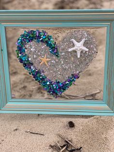 a frame with a heart and starfish in it