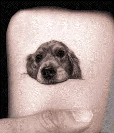 a small dog's face is shown on the side of a mans right arm