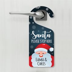 a door hanger with santa on it that says santa please stop here and ema & chicks