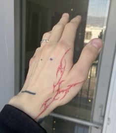 a person's hand with red ink on it