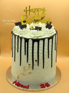 a birthday cake with white and black frosting