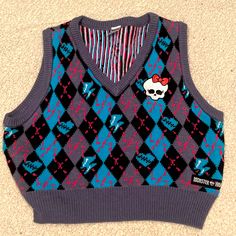 A Black, And Blue V-Neck Sweater Vest Exclusive From Spirit Halloween In A Collaboration With Monster High. Listed As A Large As Seen On Tag, However It Is Cropped. Never Worn. No Tags. No Stains. No Tears. Has A White Skull With Bow Decal On Left Side. Blue Harajuku Winter Top, Blue Harajuku Style Winter Top, Casual V-neck Halloween Tops, Monster High Merch, Skull With Bow, Monster High Costume, Monster High Clothes, Chirstmas Gift, Halloween 2022