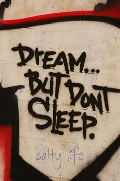 graffiti on the side of a building that says, dream but don't sleep salty life