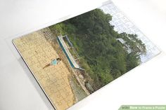 an aerial view of a person standing on a beach with jigsaw puzzle pieces