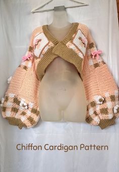 a crocheted sweater with pink flowers on it