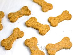 dog treats are laid out on a sheet of parchment paper with the bones in them