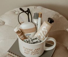 a cup filled with personal care items sitting on top of a notebook