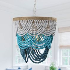 Complement your bohemian decor with this white elegant beaded chandelier. This round, four -light chandelier is shaded by a thick drape of wood beads for a vintage, shabby-chic look. the Black beads on this chandelier are elegantly draped in two tiers. It holds four light bulbs allowing the light to shine through the multiple draped layers. Parrot Uncle 4-Light Distressed White Bohemian/Global Led Beaded Chandelier | BB8828-4 Boho Chandelier, Wood Bead Chandelier, Tiered Chandelier, White Bohemian, Bohemia Style, Empire Chandelier, Beaded Chandelier, Candle Styling, Dining Room Chandelier