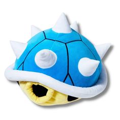 a blue mushroom stuffed animal with spikes on it's head and eyes, sitting in front of a white background