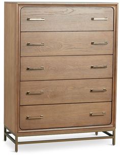 the chest of drawers is made from wood and has brass pulls on each drawer, along with