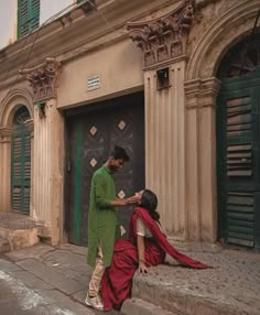 a man standing next to a woman on the street