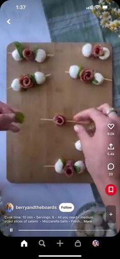 someone is making flowers on a board with toothpicks in the shape of roses