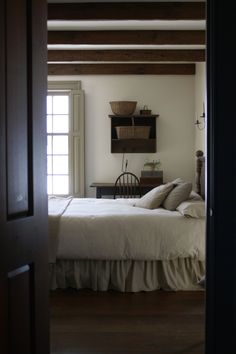 an open door leading to a bedroom with a bed