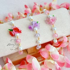 Transport yourself to a whimsical, ethereal realm with the delicate beauty of our handcrafted fairycore-inspired bracelet. This piece is designed to capture the essence of a fairy garden, where every flower glistens with a hint of magic. Key Features: Shiny Glass Beads: The bracelet is adorned with lustrous glass beads that shimmer and shine, reminiscent of dew-kissed petals in the morning light. Floral Elegance: The centerpieces of this bracelet are charming glass flower beads, each intricately Flower Petal Beads, Fairy Beads Bracelet, Whimsical Handmade Beaded Bracelets For Party, Adjustable Fairycore Bracelets As Gifts, Whimsical Beaded Bracelets, Cutesy Jewelry, Glass Bead Bracelet Ideas, Pipe Flower, Ethereal Realm