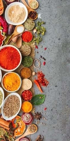 many different types of spices and seasonings in bowls