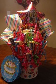 a birthday bouquet in a bucket on a table