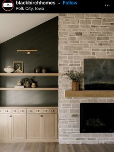 a living room filled with furniture and a fire place in front of a brick wall