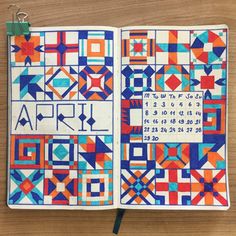 an open notebook with colorful geometric designs on it and the word art written in cursive writing