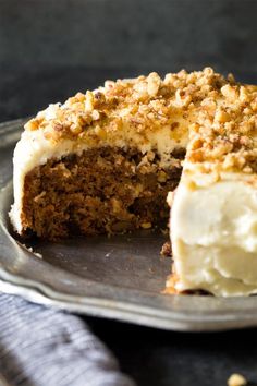 a close up of a cake on a plate with a slice missing from the cake