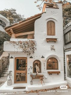 a white house with wooden shutters and windows