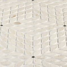 a close up view of a white tile floor with black dots on the top and bottom