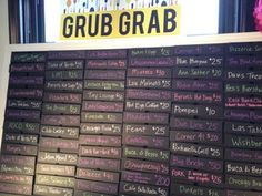 a menu board with writing on it in front of a sign that says grub grab