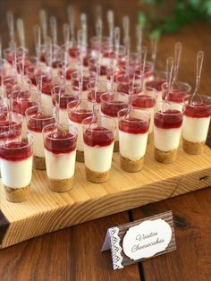 small desserts are lined up on a wooden tray