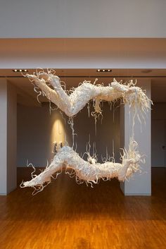 a large white sculpture sitting on top of a wooden floor