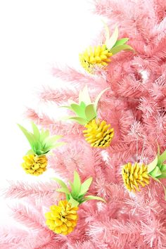 pink christmas tree decorated with pine cones and yellow flowers