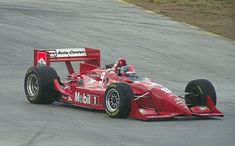 a man driving a racing car on a race track