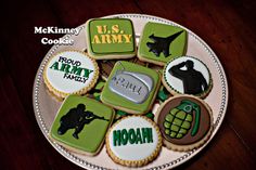 decorated cookies are arranged on a plate with the words u s army and hoohh